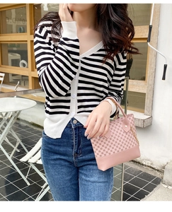 Chic pink handbag with geometric pattern and gold chain shown in a lifestyle scene