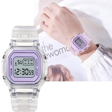 Detail view of square digital watch featuring transparent strap and purple bezel detail
