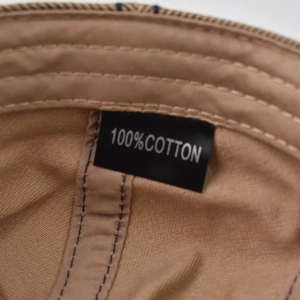 Close-up of 100% cotton label and detailed interior stitching of the breathable beret hat