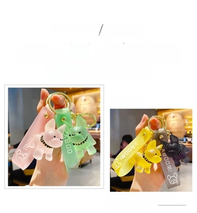 Detail of crystal resin French Bulldog keychains in pink, green, yellow, and black colors