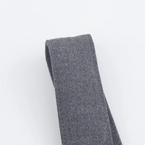 Detailed macro view of the grey textile webbing and fine woven texture of the dress straps