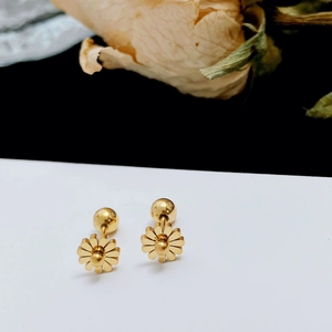 Close-up of golden daisy titanium earrings with a polished finish and screw back details