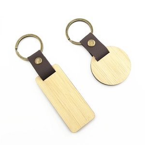 Detailed view of rectangular and round wooden keychains with brown leather straps