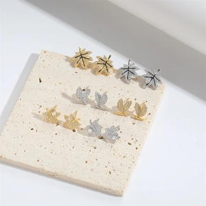 Maple leaf stud earrings set with sparkling cubic zirconia in gold and silver finishes