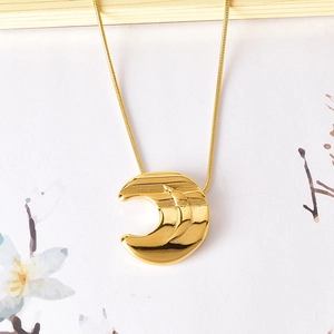 Elegant gold titanium steel necklace with moon pendant on artistic floral background