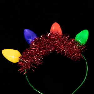 Close-up of a festive Christmas headband featuring colorful glowing LED bulbs on red tinsel