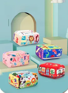 Macro shot of sensory tissue box toys with alphabet and dinosaur themes for babies