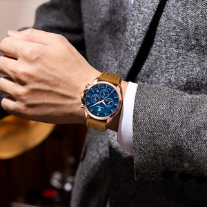 Men's waterproof chronograph watch with blue dial and brown leather strap on wrist