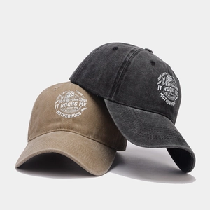 Close-up of washed cotton baseball caps in brown and charcoal with motherhood graphics