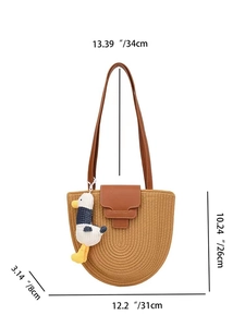 Detail view of semi-circular woven shoulder bag with dimensions and duck charm accessory