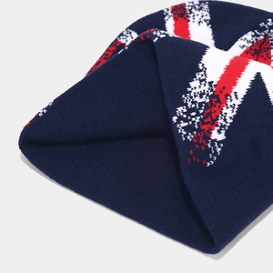 Close-up of thick navy blue knit beanie with red and white Union Jack inspired patterns