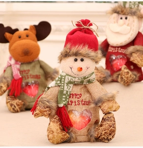 Detailed view of plush snowman Christmas gift bag with clear heart window showing an apple