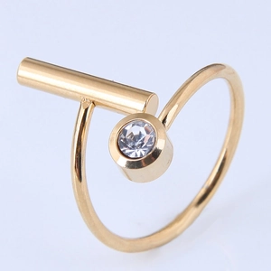 Detail of gold-plated geometric ring featuring a bezel-set zircon and open adjustable band