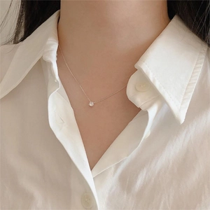 Close-up of a 925 sterling silver necklace with a sparkling round-cut zircon pendant