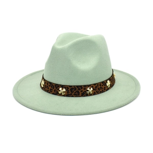Detail of light mint green wool fedora with leopard band and gold star rivets