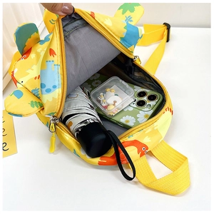 Top view of yellow cartoon dinosaur backpack showing spacious inner compartment