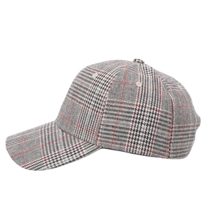 Detailed side view of houndstooth baseball cap with classic grey plaid and red stripes