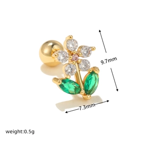 Macro detail of a 9.7mm gold flower earring with green zircon and a ball screw back