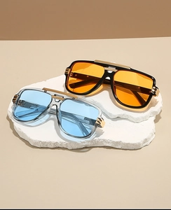Detailed view of square sunglasses with gold metal bridge accents and colorful lenses