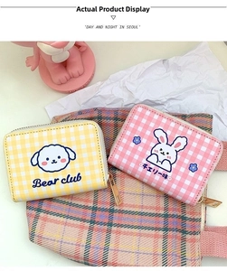 Close-up of pink and yellow checkerboard coin purses with cute bear and rabbit cartoons