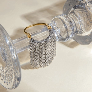 Luxury two-tone 18k gold and silver stainless steel chain tassel ring on glass