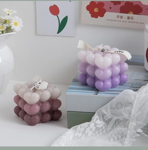 Detail of gradient heart-shaped bubble candles with decorative Just For You ribbons