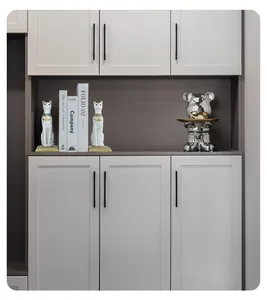 Detail view of a minimalist entry cabinet with white doors and dark grey frame contrast