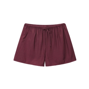 Detail of burgundy textured shorts with elastic waist and matching drawstring cords
