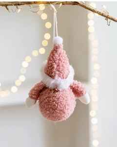 Detailed view of a pink plush Santa gnome ornament hanging on a festive tree branch
