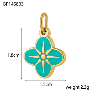 Macro shot of 1.5cm green four-leaf clover pendant with star pattern and gold plating