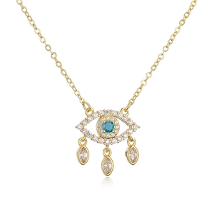 Macro detail of 18K gold plated copper crying eye necklace with blue and white zircon