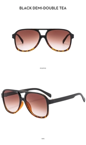 Detail view of double bridge aviator sunglasses with black demi frames and tea gradient lenses