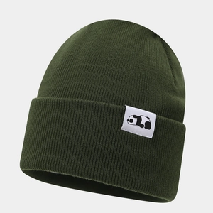 Detailed view of the dark green knitted beanie featuring a minimalist panda logo patch