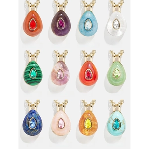 Grid display of 12 teardrop-shaped birthstone necklaces in vacuum-plated gold finish
