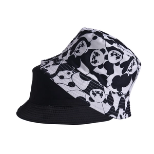 Detail view showing black and white panda print versus plain black cotton bucket hat