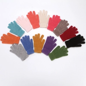Flat lay of colorful knitted wool gloves for winter in various vibrant color options