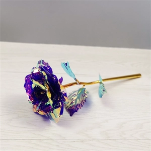 Detailed view of iridescent holographic rose petal texture and golden stem on wood surface