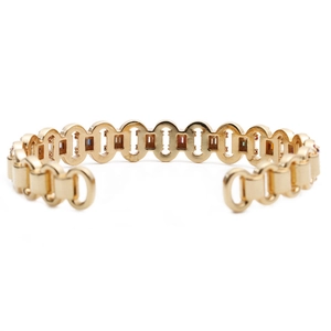 Close-up of golden bangle with circular links and multi-color micro-inlaid zircon
