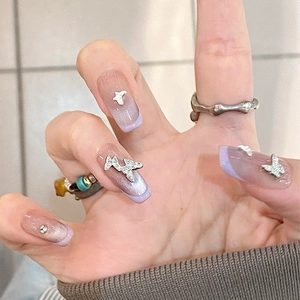 French purple cat eye press-on nails with silver 3D butterfly and rhinestone accents