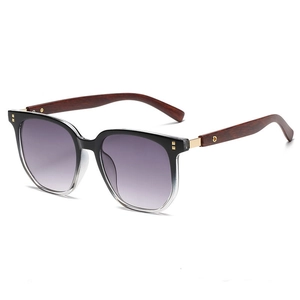 Detail of vintage polygonal sunglasses featuring wood grain temples and purple gradient lenses