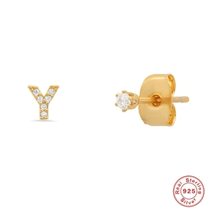 Detailed macro view of S925 sterling silver gold letter Y and round diamond stud earrings
