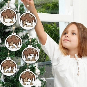 Macro detail of wooden Christmas animal ornaments being hung on a tree by a child