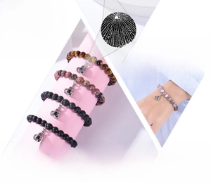 Detail of stone beaded bracelet with heart pendant showing I Love You projection feature