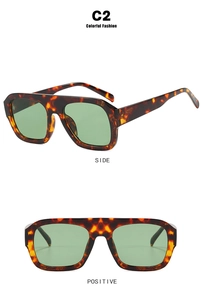 Detail view of retro square tortoise sunglasses with green tinted lenses and thick frames