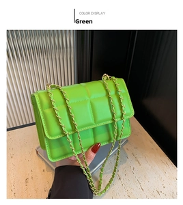 Detailed view of neon green quilted crossbody bag with luxury gold chain and stitch texture