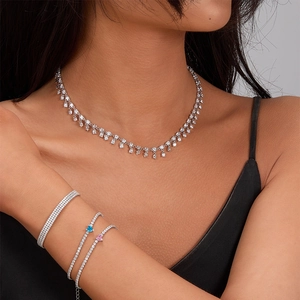 Detail of luxury S925 silver necklace with sparkling zircon tassels on a female model