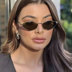 Close-up of retro polygonal tea sunglasses with wood grain temples and metal earrings