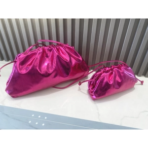 Detail of rose red metallic cloud bags in two sizes with pleated texture and thin straps