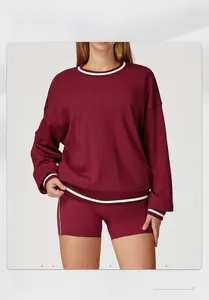 Detail of burgundy color-block sweatshirt with white stripes and matching slim shorts