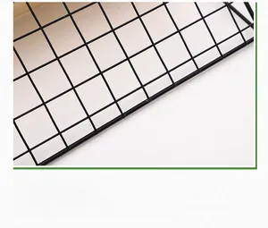 Detail of black iron wall grid with reinforced hanging hook and rust-proof finish